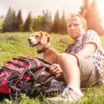 A man out hiking with his dog