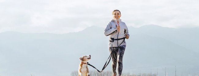 woman running with dog outside