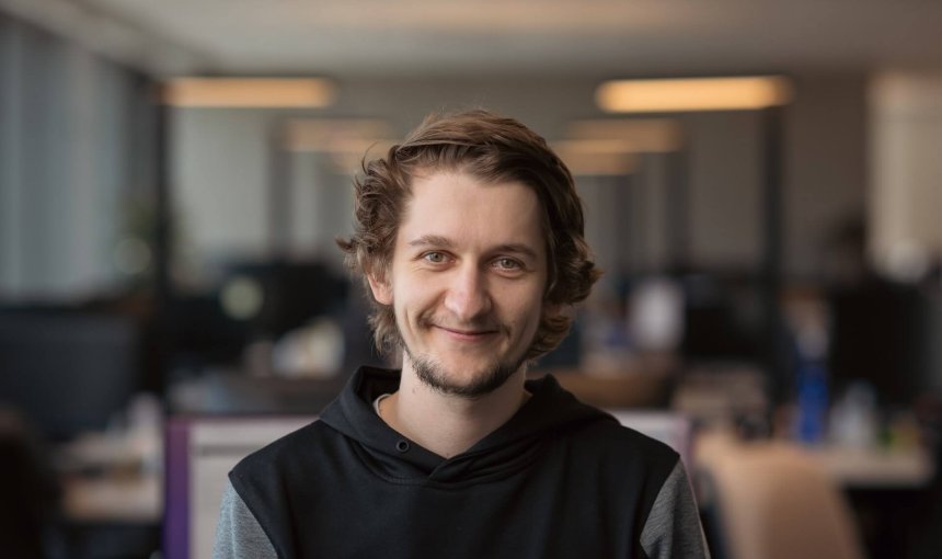 man smiling looking at camera in an office