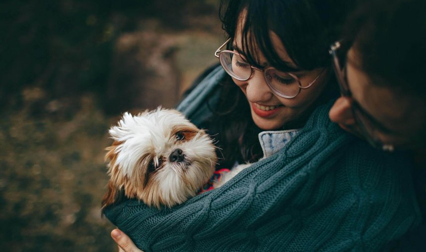 couple holding small dog