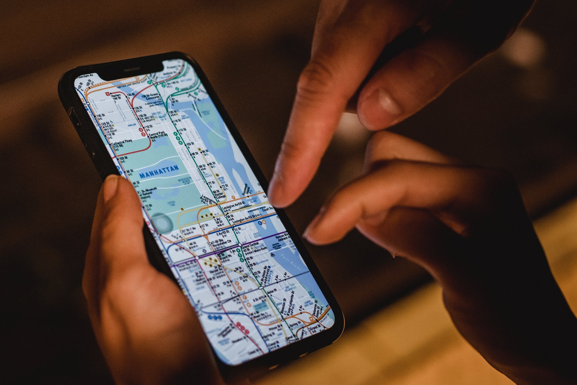 A closeup of a mobile screen showing a map with two people checking it