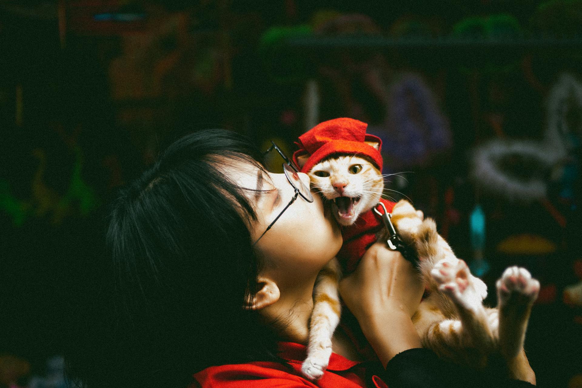 A woman kissing a cat