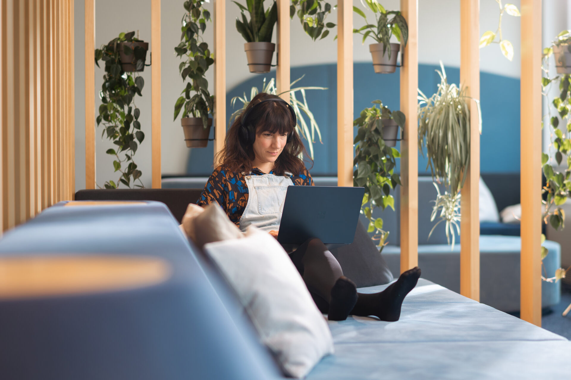 A translator at Tractive working in a green office space