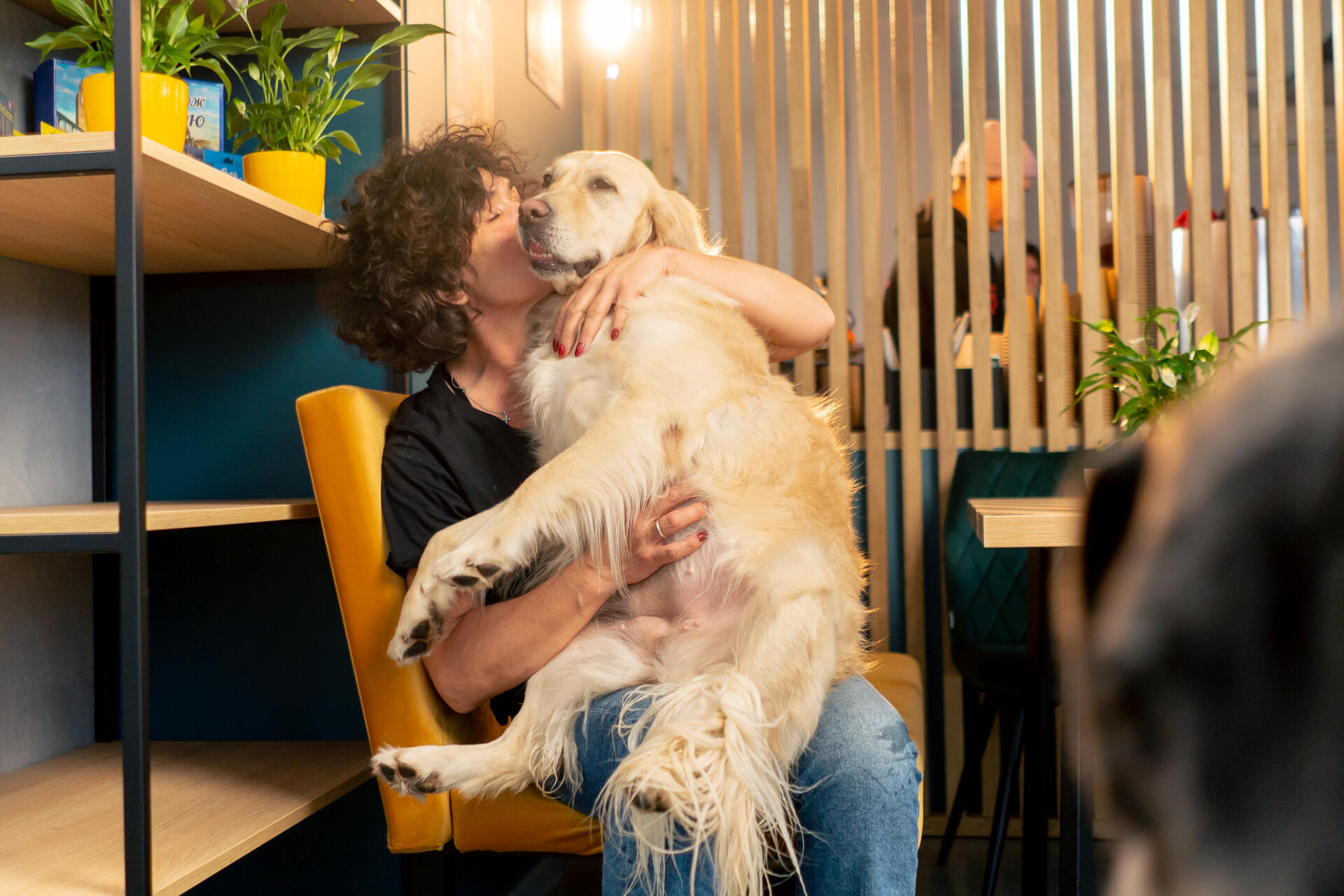 A woman hugging her dog indoors