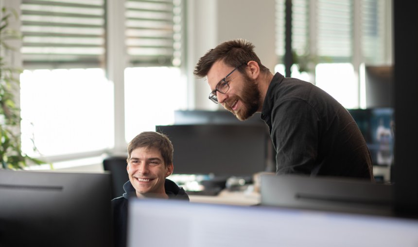 A pair of Tractive employees working together on a project