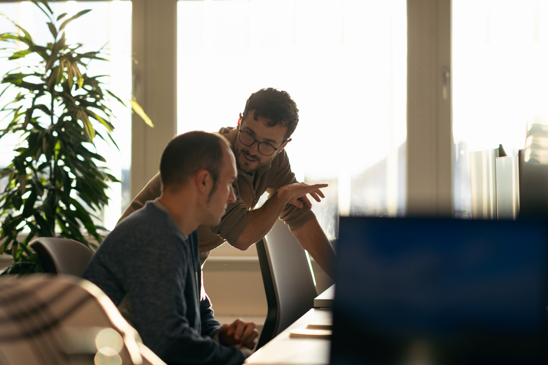 A pair of Tractive employees working together at the office