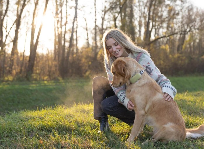 woman and golden retriever dog outside