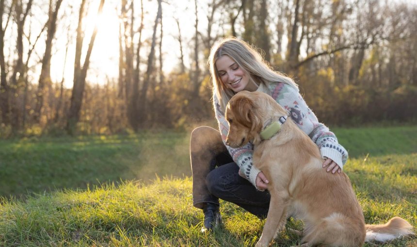 woman and golden retriever dog outside